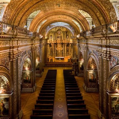 The interior of La Compania Jesuit Church in Quito in Ecuador, South America. Much of the ornate sculpture is made from local volcanic pumice which has then been covered in gold leaf (supposedly 7 tons of it)